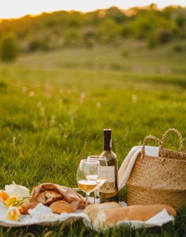 picnic with wine and croissants at sunset 