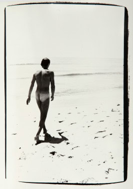 Naked Jon Gould walking on the beach 