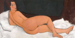 A painting depicting a naked woman lying half-turned on a bed 