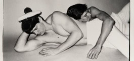 Photo of two half naked guys lying on each other 