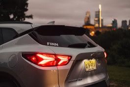 Rear of a car with a FINN sticker on the glass 