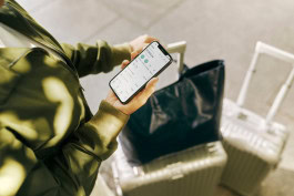Person with suitcases looking at mobile N26 app home page 