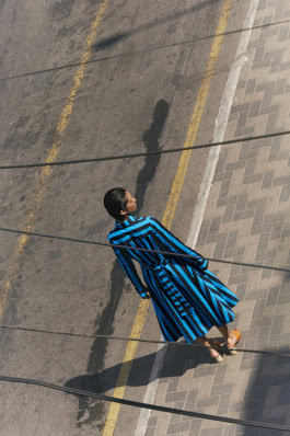 Model walking down the street in a Maqu, K dress, top view photo 