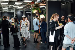 People chatting at a fashion event in a clothing store