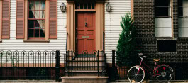 The front door of a house and a bicycle nearby 