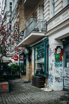 Photo of the facade of a house with a graffiti-covered wall 