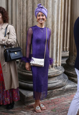 Woman posing in blue turban and blue shiny tight dress