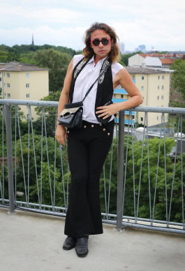 A man posing in a stylized cowboy outfit