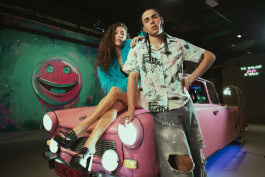 Man and women are posing near the car in the Upside Down Berlin