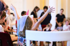 Little girl is happy and raises her hands up at Young Euro Classic