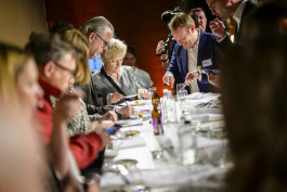 People taste food at a long table at Berlin Food Night 2024