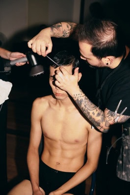 Marke's male model gets his hair done backstage at Berlin Fashion Week