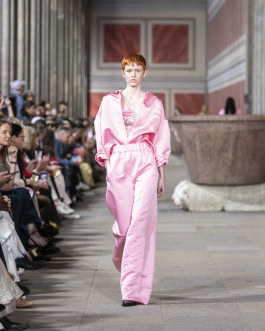 Odeeh female model in a pink silk suit walks the catwalk at Berlin Fashion Week