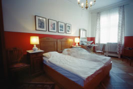 photo of a room in Hotel Bogota during the day with two beds, on one of the beds lies a blurry silhouette of a person