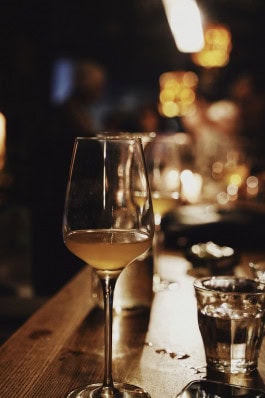 A glass of white wine stands on the bar counter in The Rad bar in Berlin 