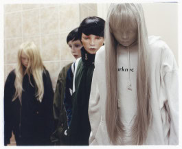 Photo of four girl dolls standing in a room