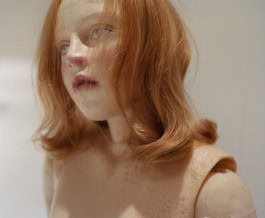 Red-haired girl doll looks away