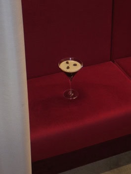 Photo of a candle in the form of a glass with a coffee drink