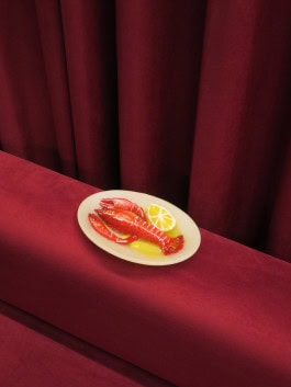 Photo of candle in the shape of a plate with lobster and lemon