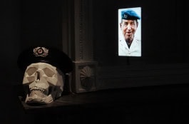 skull in military beret next to photo of military man