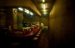 Photo of a man at the bar in a deserted bar