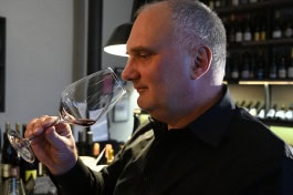 Peter Brock tastes wine at Mauerwinzer bar in Berlin