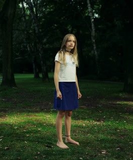 photo of little girl barefoot in the garden