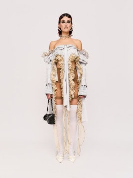 Woman in dress, tights, shoes and bag from tHERAPY Berlin