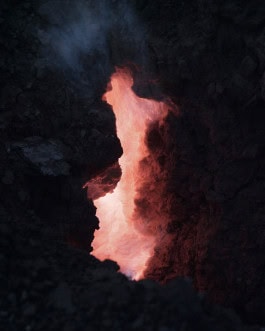 A crevice in the rock from which warm sunlight pours