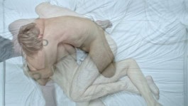 Blurry photo of naked man in different poses on bed