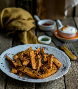 Fried pumpkin sticks on a plate on a served table