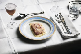 Fish Crudo on the table in Papillon, next to a glass of espresso martini