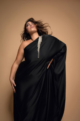 Girl posing with hand on hip in black long one shoulder dress