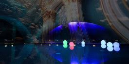 Large indoor pool illuminated by antique paintings in Liquidrom