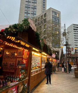 Berlin Christmas Market, people strolling between decorated Christmas stalls 