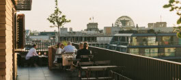 Château Royal rooftop terrace, people sitting at tables, drinking and chatting