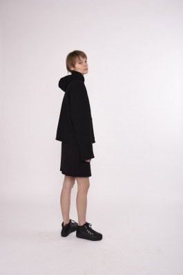 woman posing in black hoodie, shorts and boots