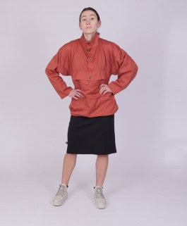 woman posing in red jacket, black midi skirt and white boots