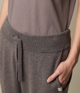 close up view of grey t-shirt tucked into grey pants 